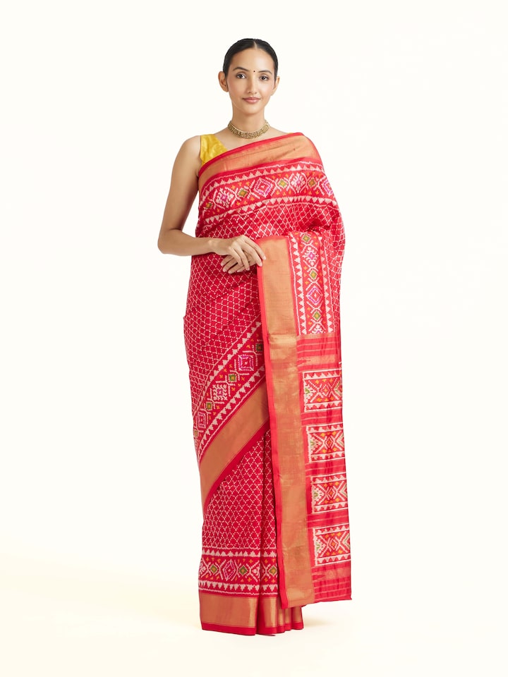 front view of red weft ikat silk saree with traditional pattern