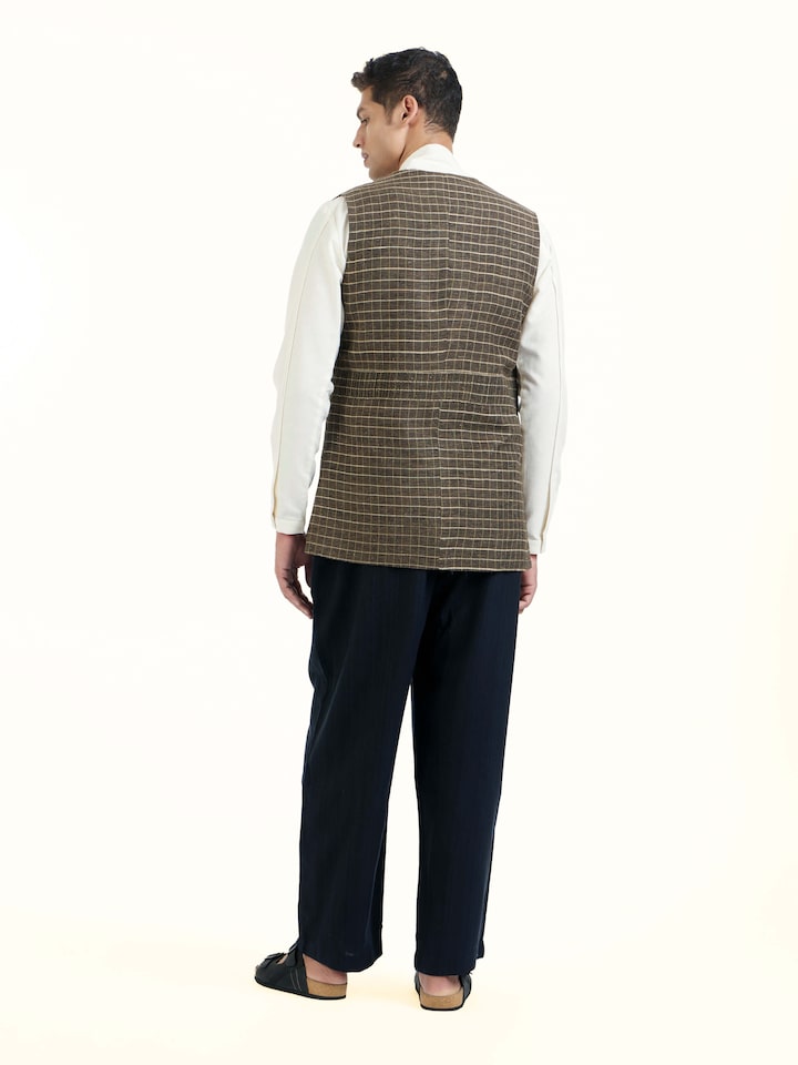Back view of brown handloom sleeveless jacket with clean structured finish