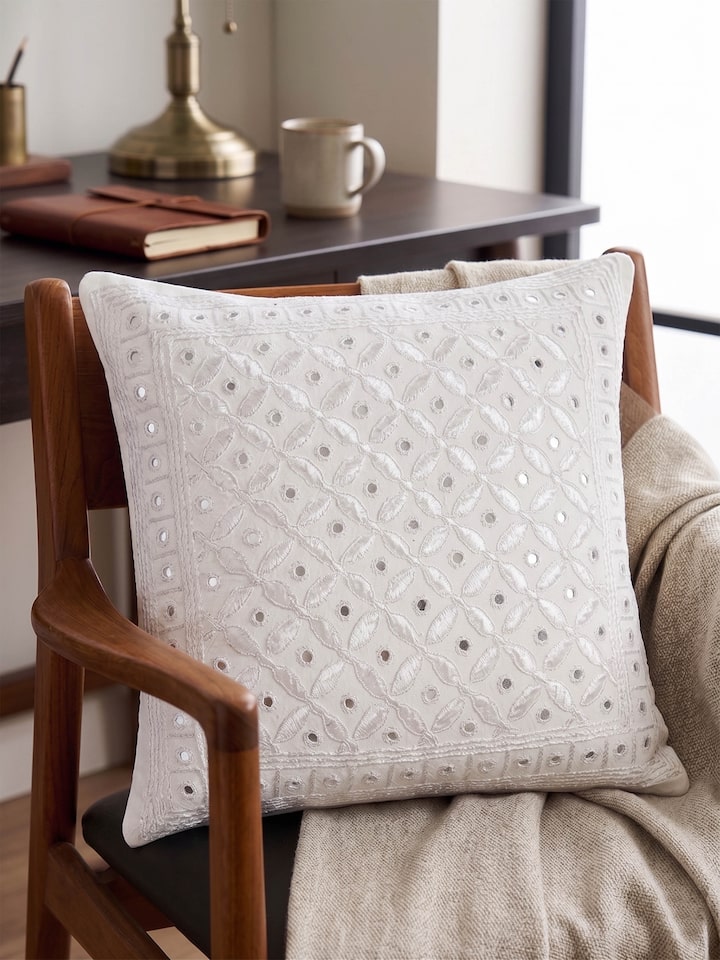 Lifestyle view of the Swadesh Lippan White Pakko Allover Hand Embroidered Cotton Cushion Cover