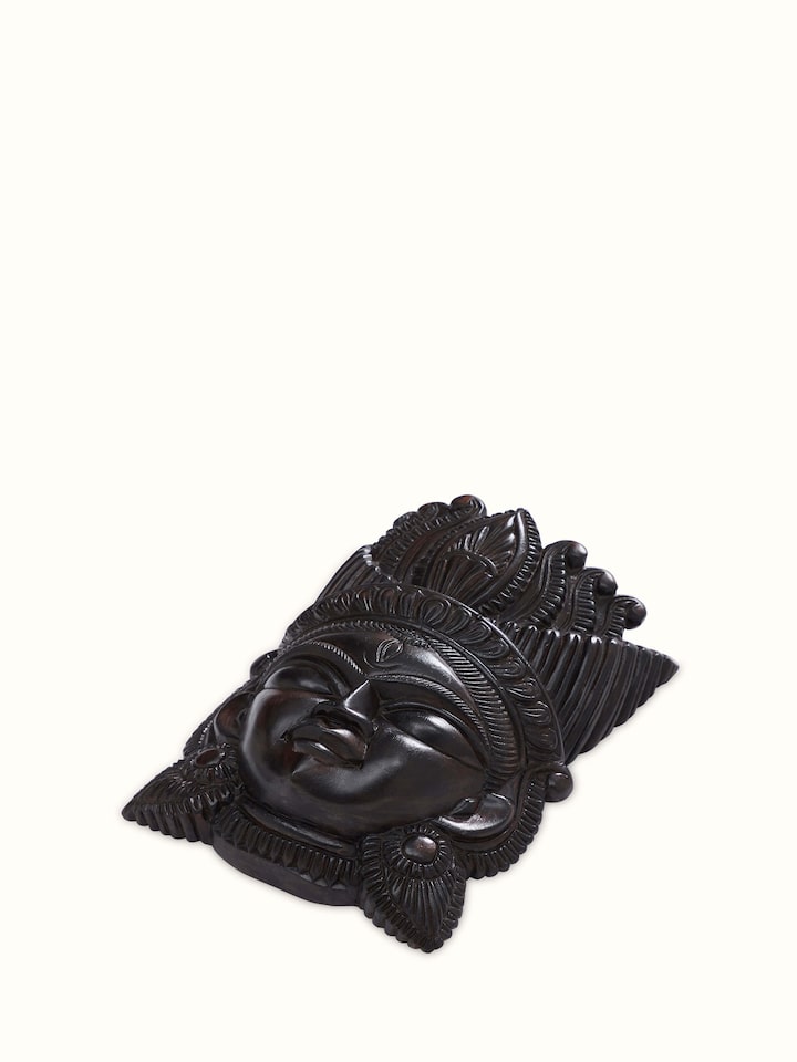 Detail shot of Kushmandi goddess wall mask highlighting handcrafted texture