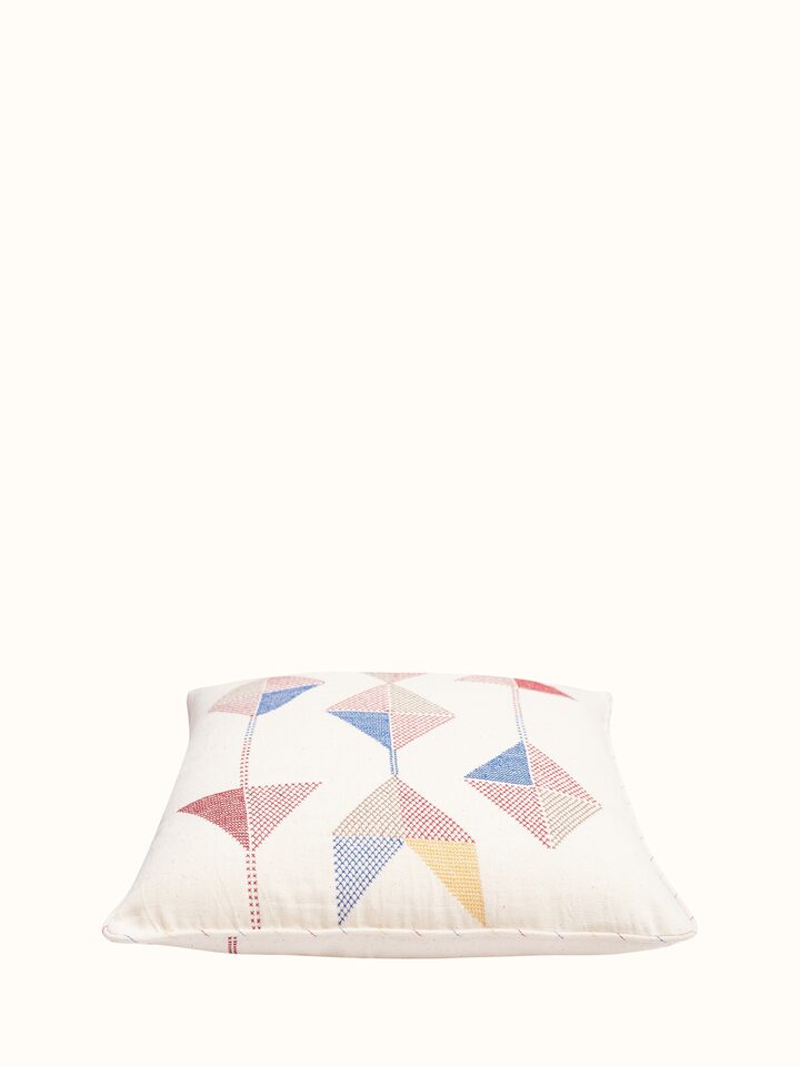 Angled view of Uttarayan hand embroidered cotton cushion cover