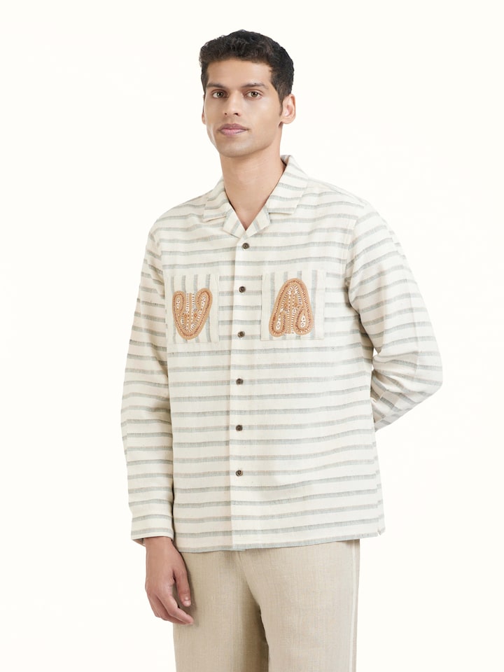 Angled view of Ivory Kutchi Embroidered Shirt revealing the depth of its color and intricate pattern
