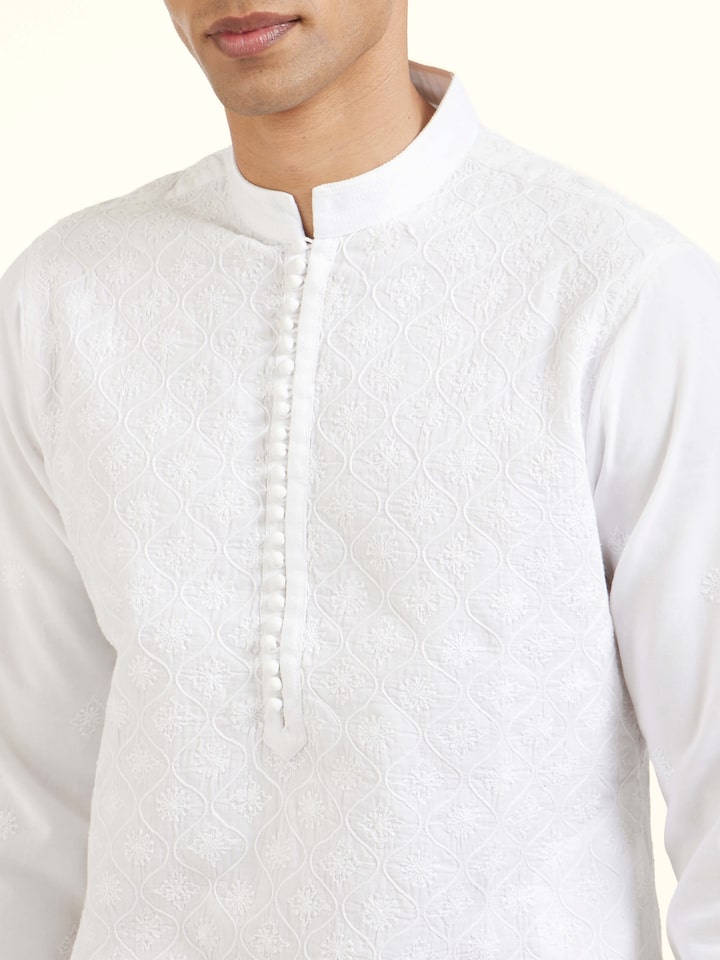 Detail view of white cotton chikankari long kurta showing fabric texture