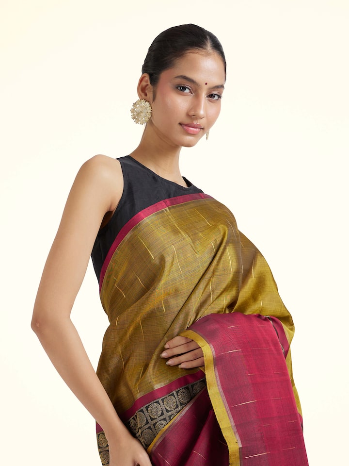 Angled view of brown silk Kancheepuram saree highlighting traditional weave and sheen
