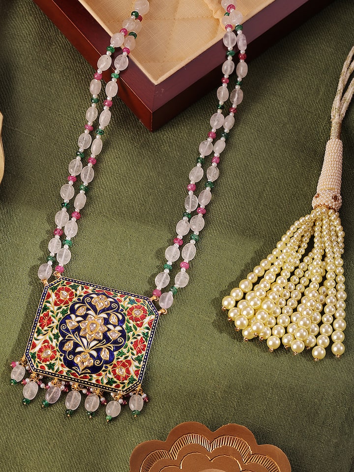 Overhead view of Jaipur Meenakari pendant and chain showcasing the circular pendant and delicate gold links.