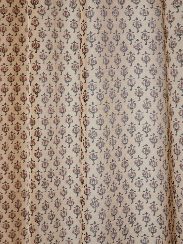 Detail showing cotton silk weave and block printed buti in rust shade.