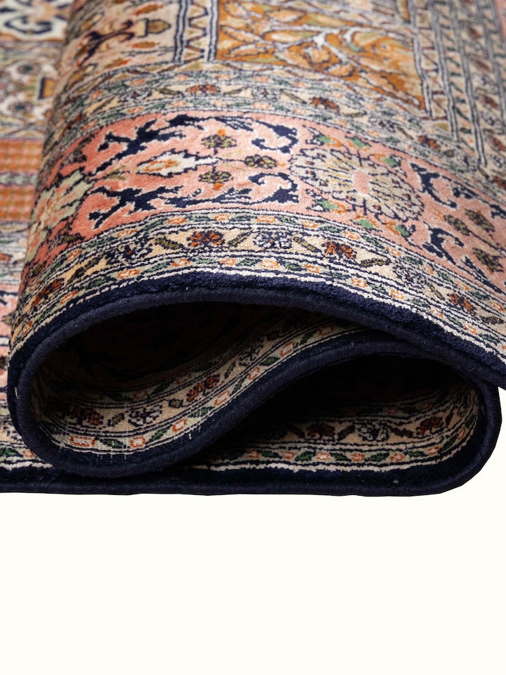 Detail view of Traditional Persian Pink Dabdar Kashmir Silk Hand-Knotted Carpet highlighting the intricate pattern and pile texture, from a differe...