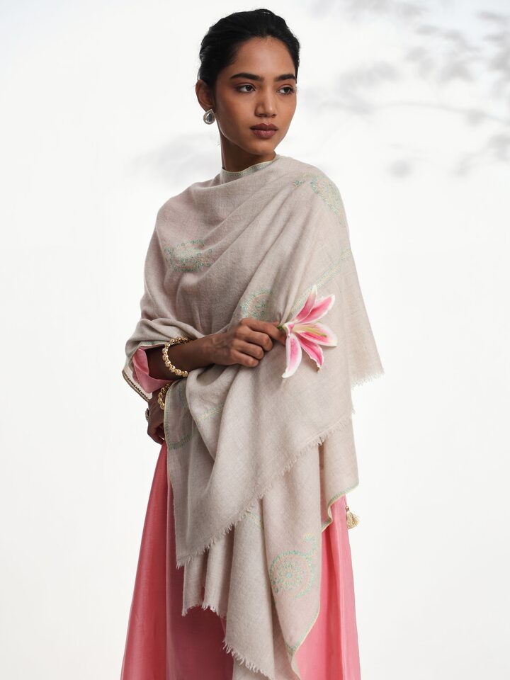 Angled view of beige jalidar sozni embroidered stole highlighting detailed motifs and texture