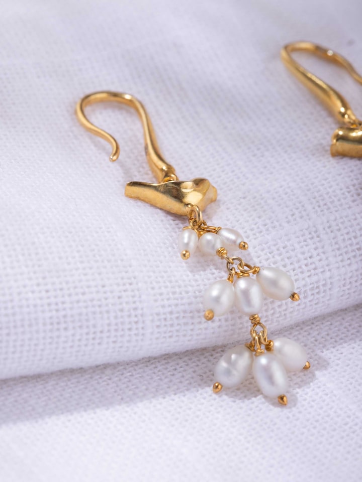 detail view of silver smithing drop earrings texture