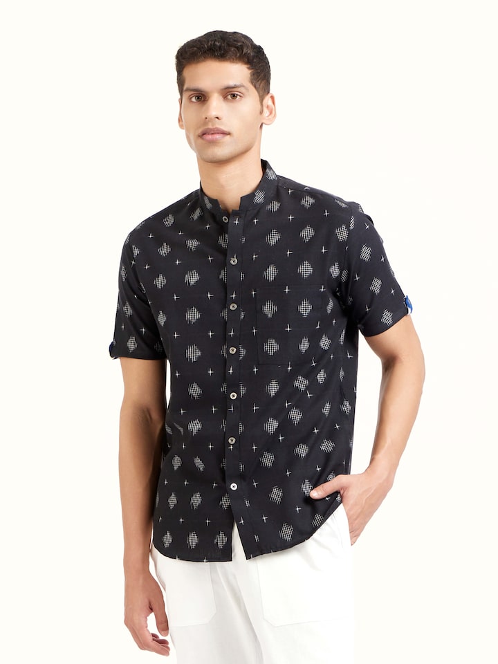 Angled view of black cotton Telangana Ikat shirt highlighting classic Ikat weave and texture