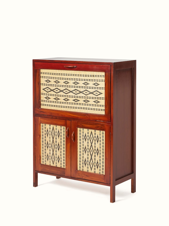 Close-up of teak wood and cane bar cabinet, focusing on the intricate cane detailing and wood finish.