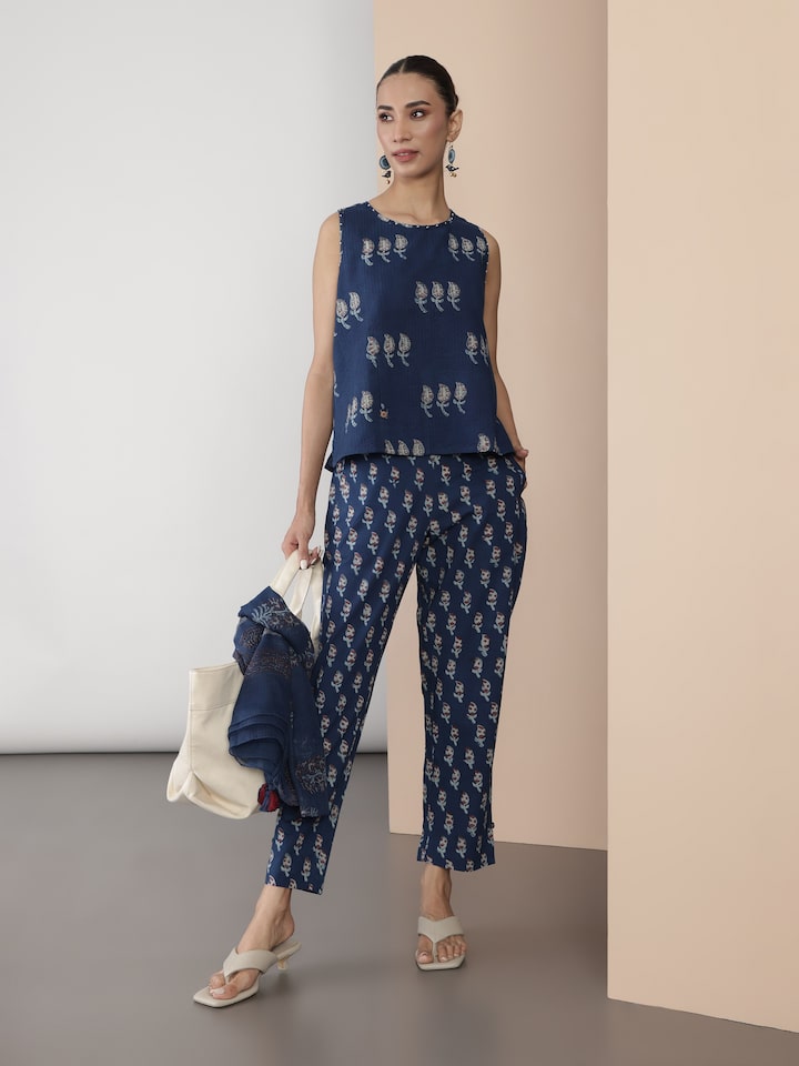 Side pose of model wearing blue Dabu block printed pant showcasing side seam and print alignment.
