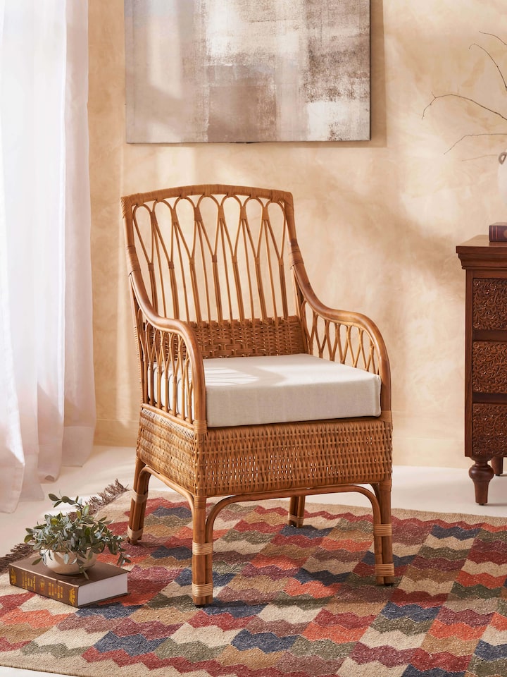 Side view of the cane study chair with upholstery, showcasing the intricate cane work and stylish design.