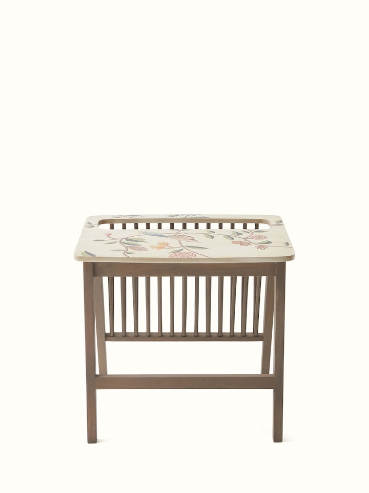 Detailed view of the miniature painting on the mango wood magazine rack, highlighting the artistic elements and vibrant colors.