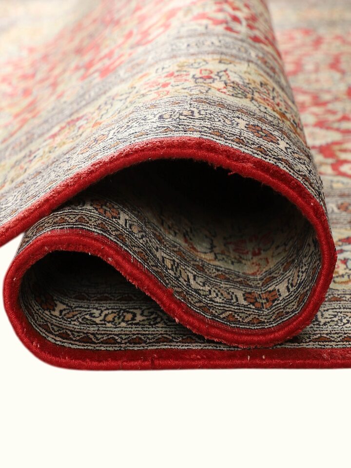 Side-angle view of the Traditional Persian Navy Ochre Tabriz Kashmir Silk Hand-Knotted Carpet