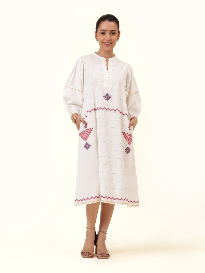 Front view highlighting the subtle off-white cotton dress, adorned with traditional Rajasthani embroidery for a graceful appeal.
