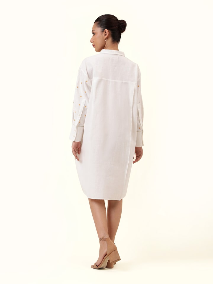 Back view of off-white cotton embroidered shirt displaying clean back and light structure.