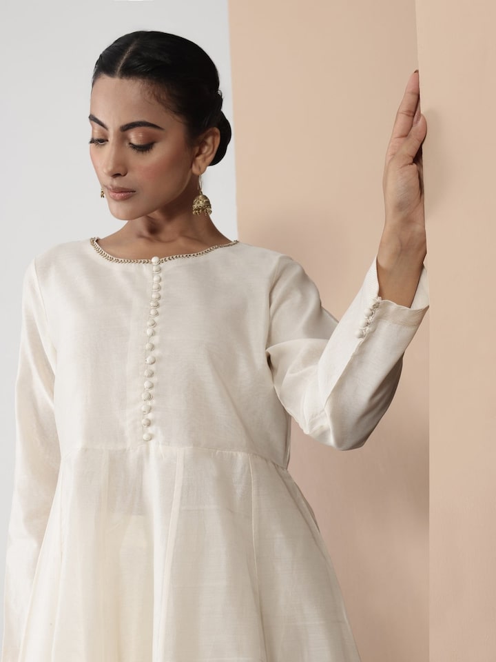 Close-up view of model posing in off-white Anarkali Chanderi kurta with fine detailing and traditional charm.