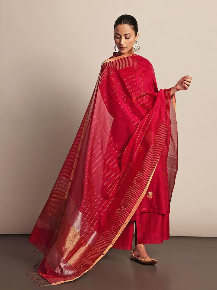 Lifestyle view of fuschia cotton silk Chanderi kurta showing silhouette and embroidery details.