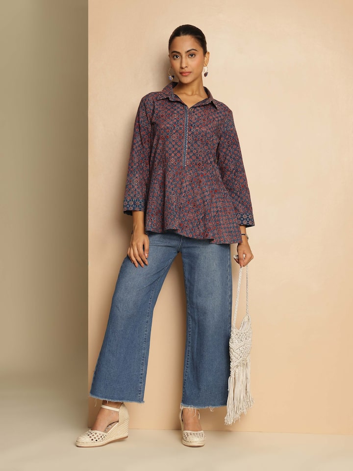 Lifestyle view of blue Ajrakh print peplum top paired with contrast trousers