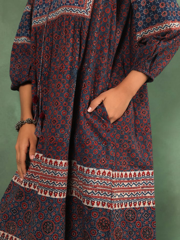 Detail view showing neckline, print, and soft gathers of summer dress