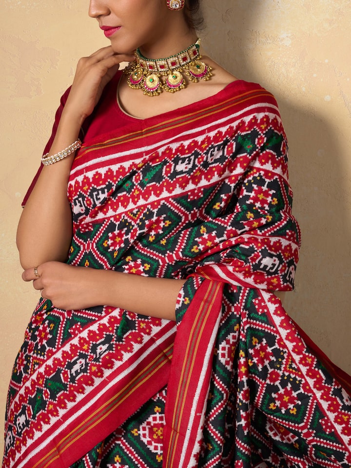 Red mulberry silk Patan Patola saree detail shot capturing fine weaving details and border design