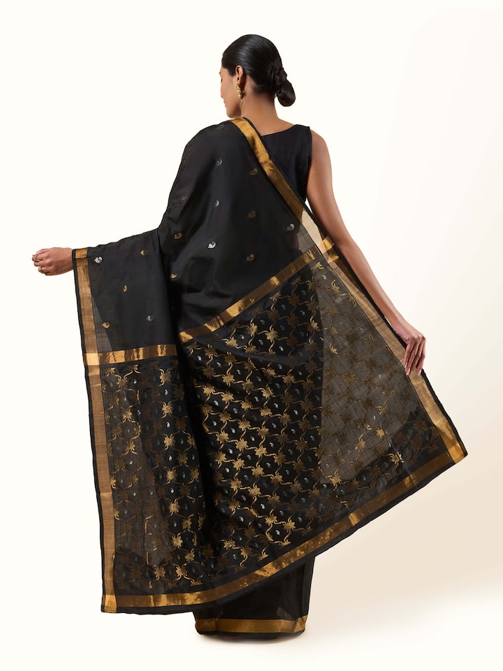 Back view of black Uppada Jamdani saree showing pleated drape and ornate pallu fall