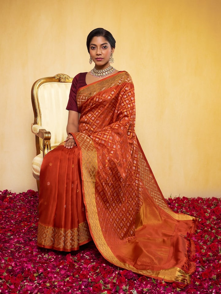 Lifestyle view of rust Uppada Jamdani saree draped elegantly with blouse
