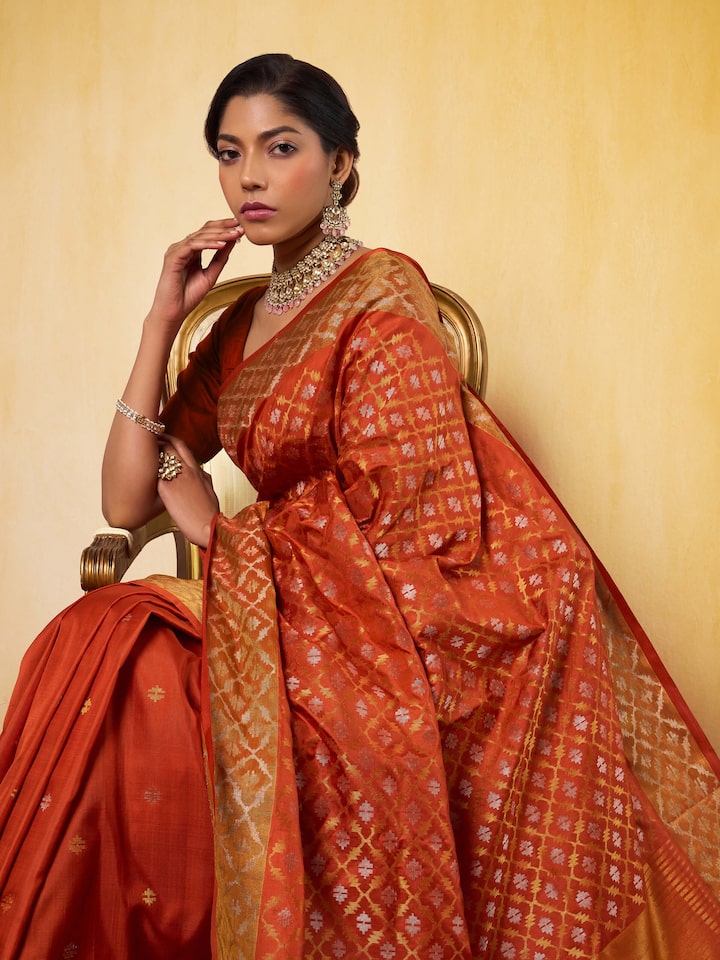 Angled view showing pallu and Jamdani weave on Uppada rust silk saree