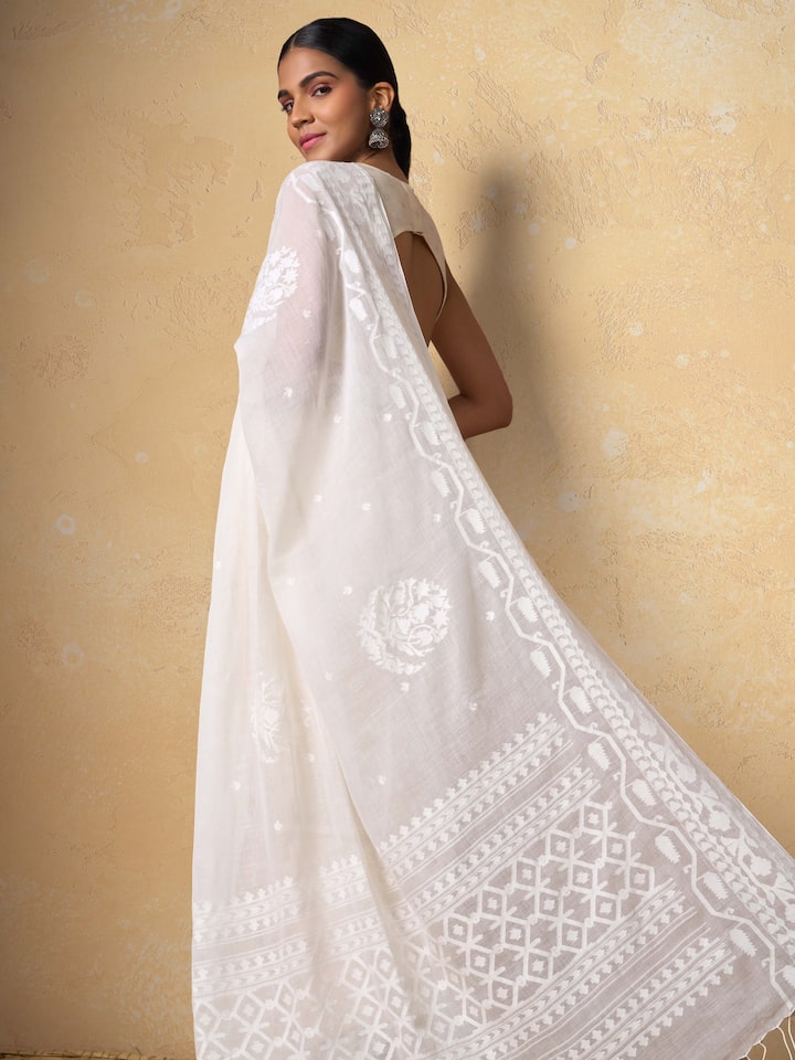Angled view of off-white cotton saree capturing woven patterns