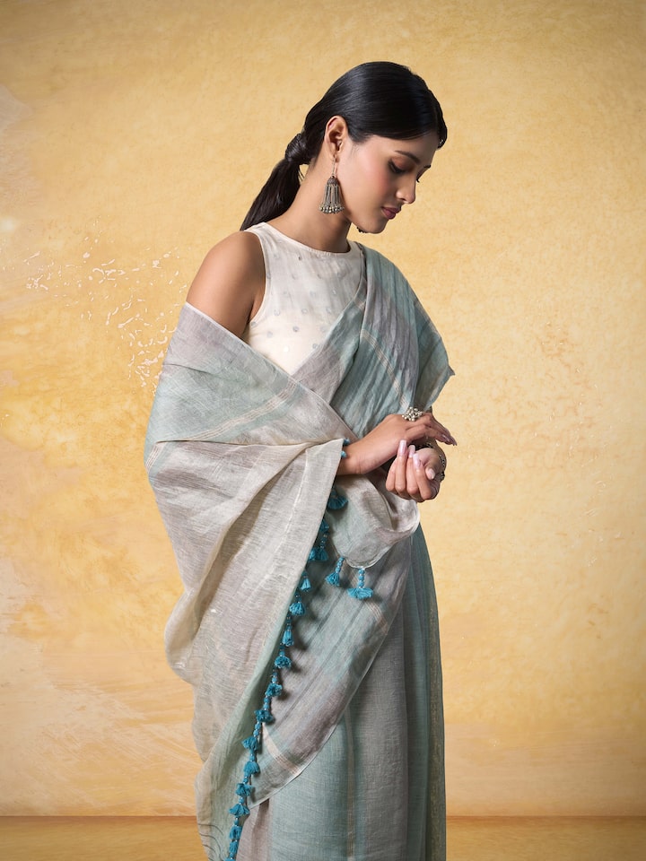 Close-up to showcase the linen’s natural texture and golden detailing.