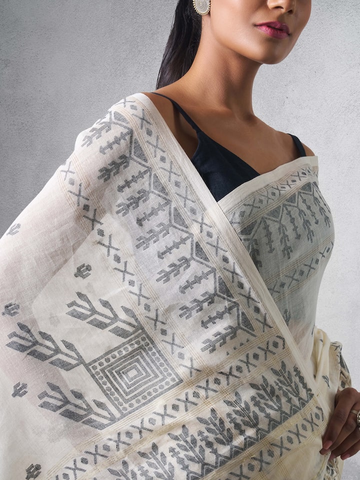 Detail shot of off-white cotton Jamdani saree revealing fine Jamdani weave.