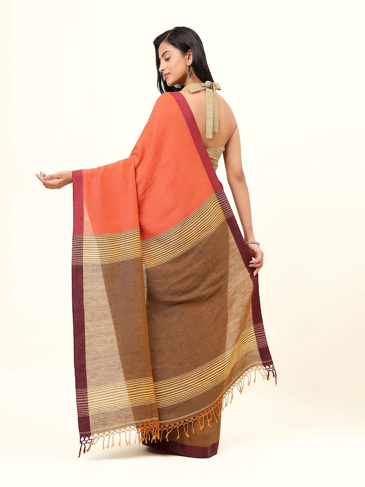 Back view of grey linen saree displaying straight pallu and elegant fall.