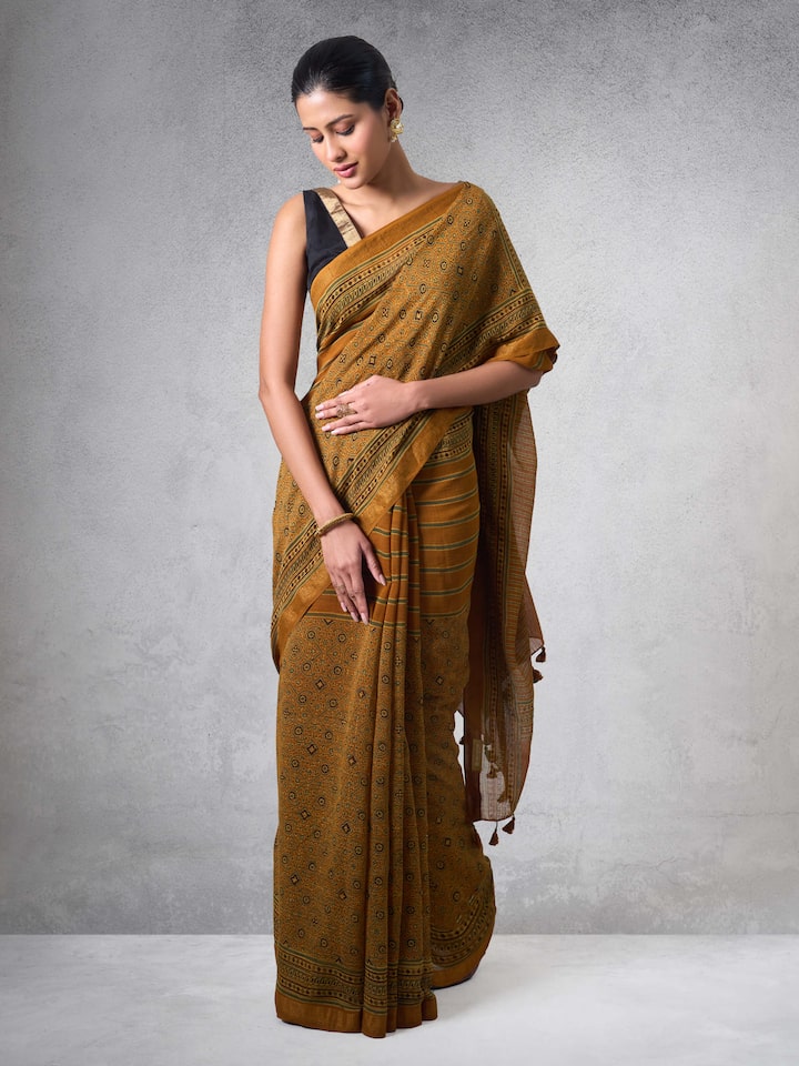 Lifestyle view of mustard Ajrakh saree paired with matching blouse.