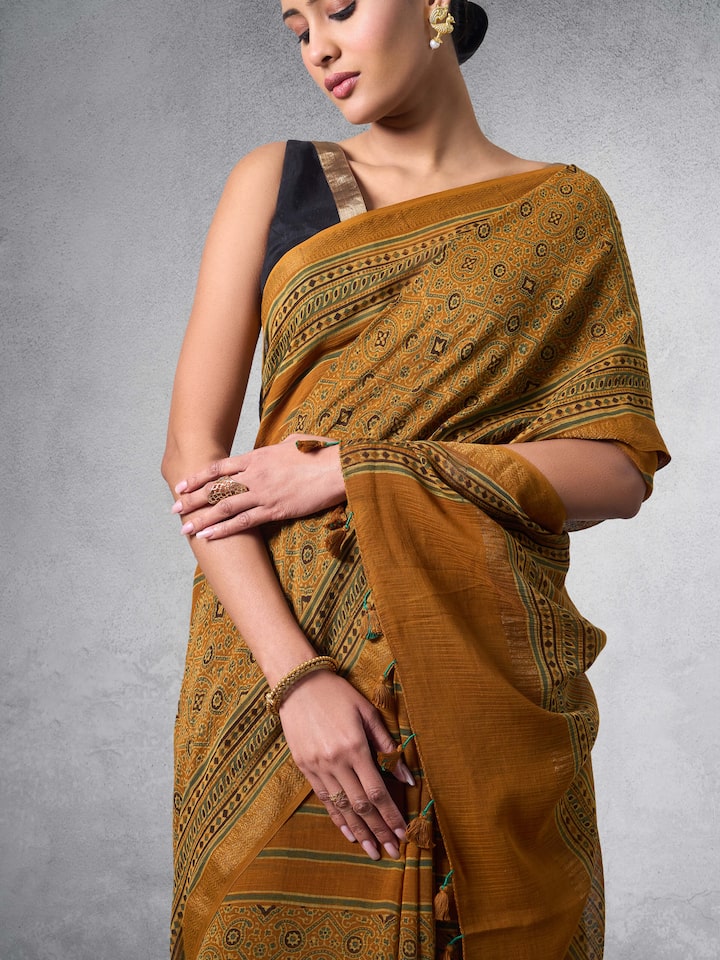 Detail shot of Ajrakh hand-block prints and zari pallu highlights.