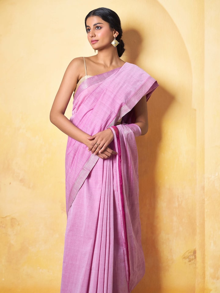 Angled view of pink cotton and gossamer saree showcasing woven texture and pallu