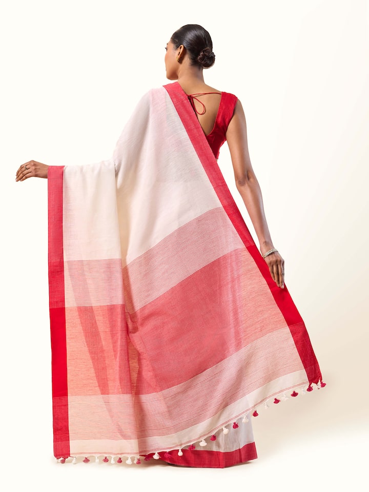 Back view emphasizing the pallu and classic woven border.