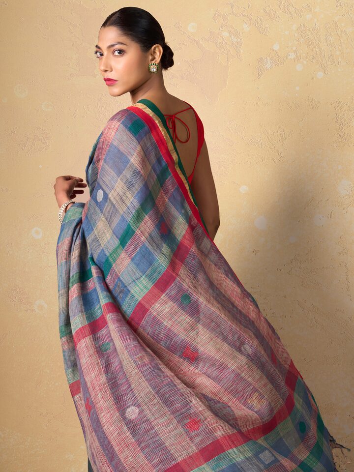 Angled pose of model in Green Linen Cotton Saree showcasing lightweight linen cotton fabric.