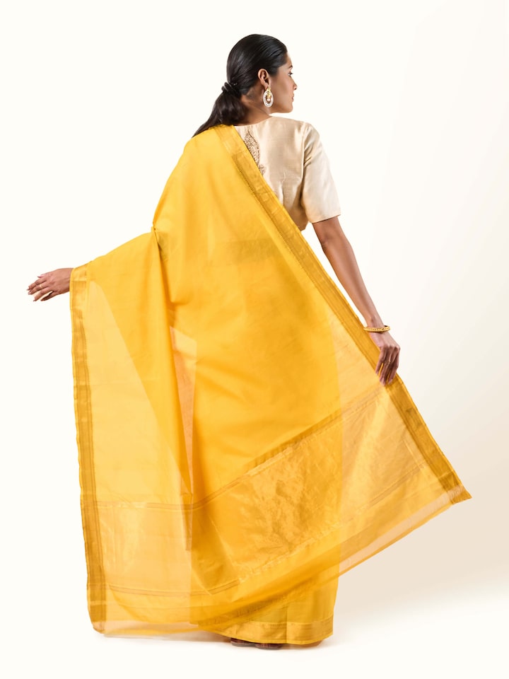 Back view of yellow cotton Mangalgiri saree showing full fabric length and border
