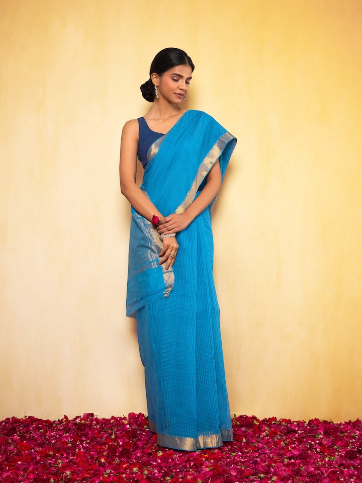 Front view of model draped in blue and gold Mangalgiri cotton saree, showcasing its rich weave and contrast pallu.