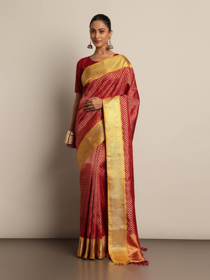 Detailed front view of model showcasing red Kancheepuram saree draped elegantly with rich zari details and classic silk texture.