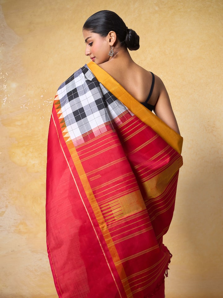 Angled view highlighting pallu design and sheen of grey Kancheepuram silk saree