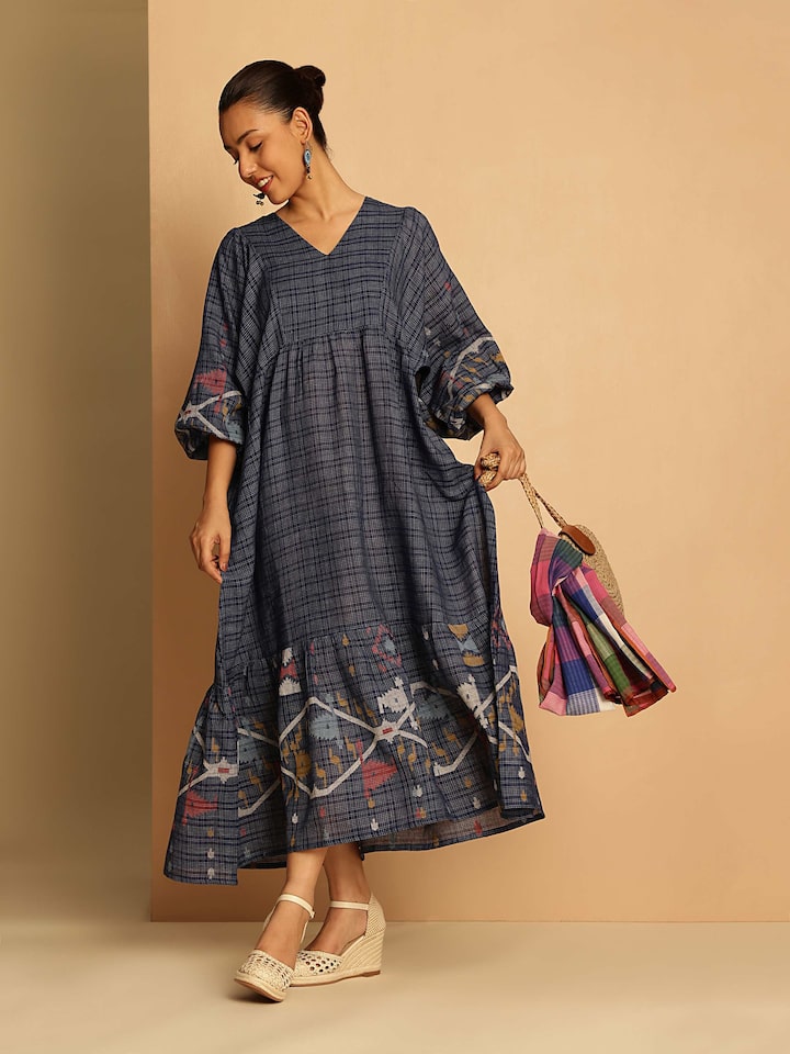 Lifestyle image of blue cotton Jamdani dress worn casually, highlighting flowy sleeves