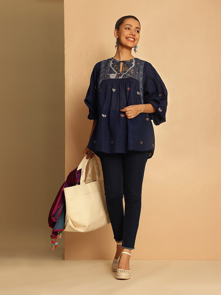 Model wearing blue Bengal Jamdani cotton top styled in a relaxed bohemian look.