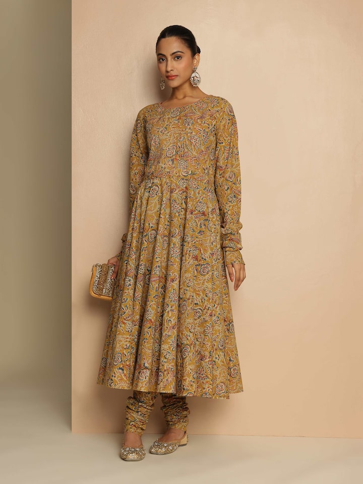 Model wearing Yellow Cotton Kalamkari Kurta featuring intricate hand block prints and a straight silhouette.