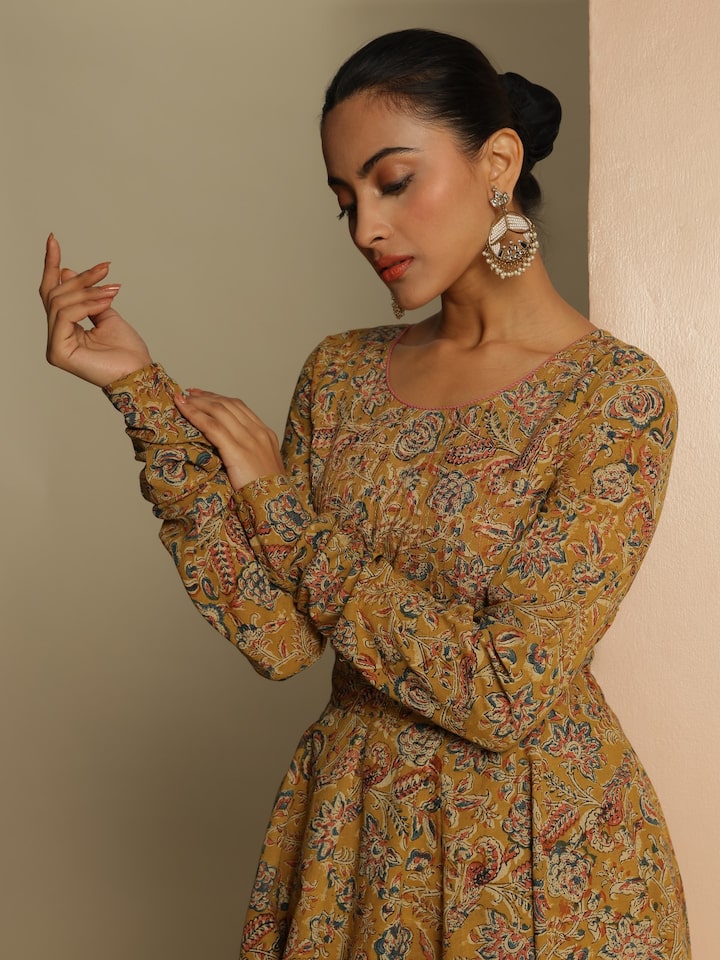 Side view of Yellow Kalamkari Block Printed Kurta on model, highlighting detailed sleeve and pattern.