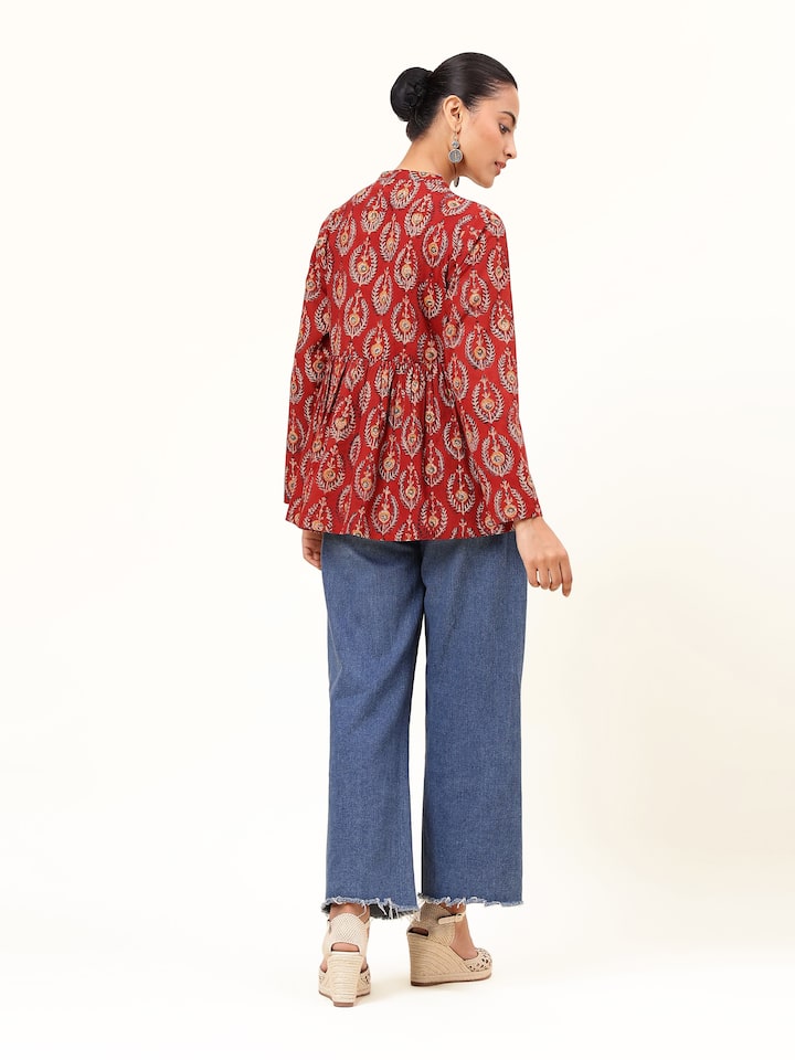 Back view of red cotton Kalamkari peplum top featuring block printed design and gathered waist.