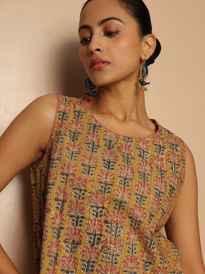 Side lifestyle shot of yellow cotton top with Kalamkari print highlighting sleeve design