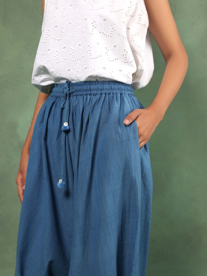 Angled view highlighting roomy silhouette and lightweight texture of indigo harem pants
