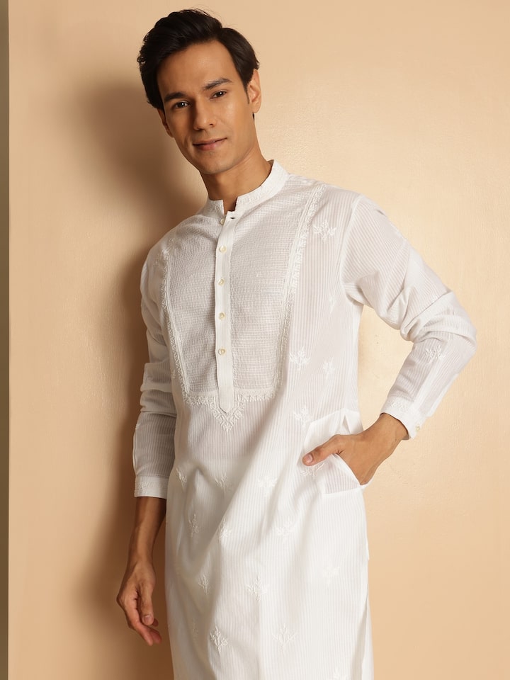 Angled lifestyle view of white embroidered cotton kurta showing delicate thread work